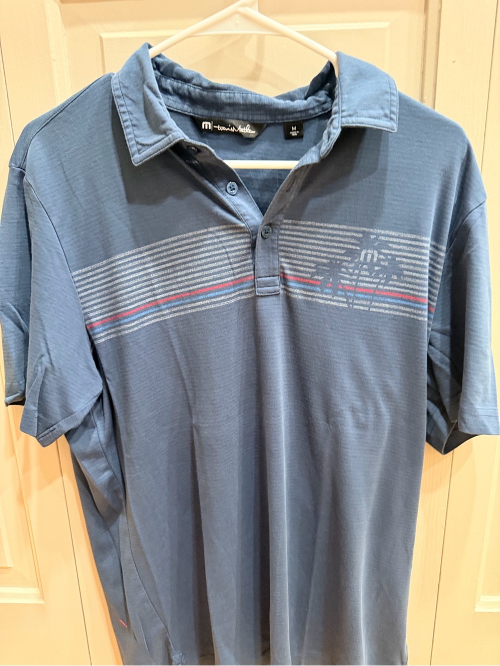 Travis Mathew Blue Polo with Subtle Stripe Detail